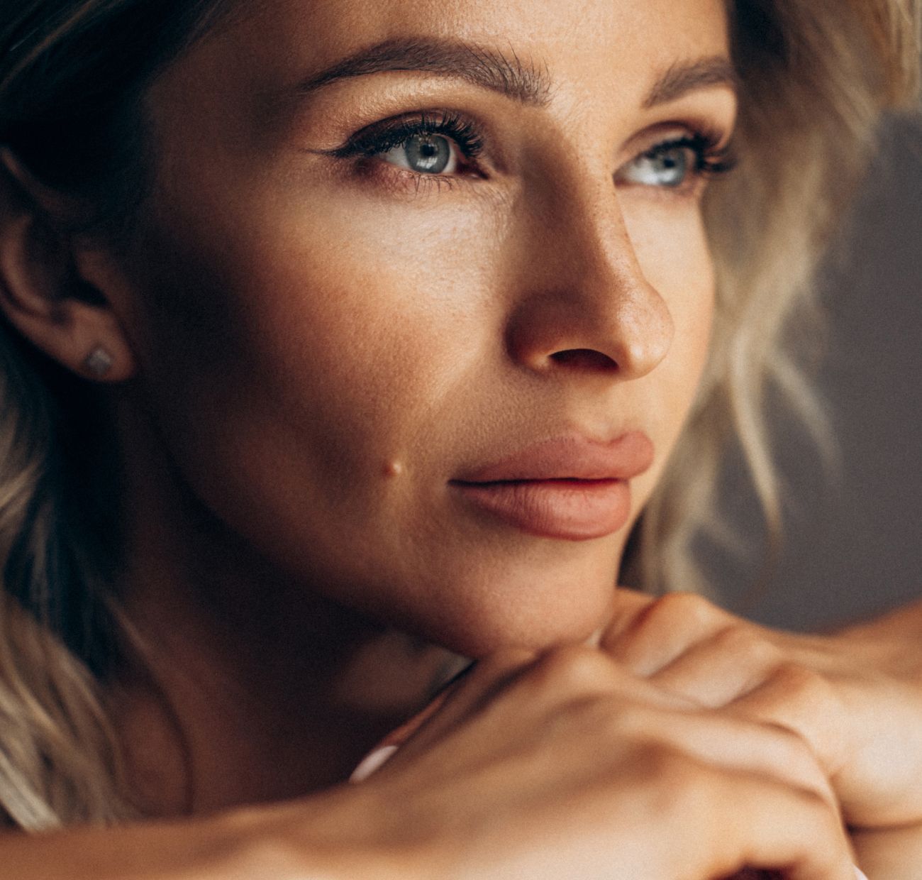 Close-up of woman with striking features and expression.