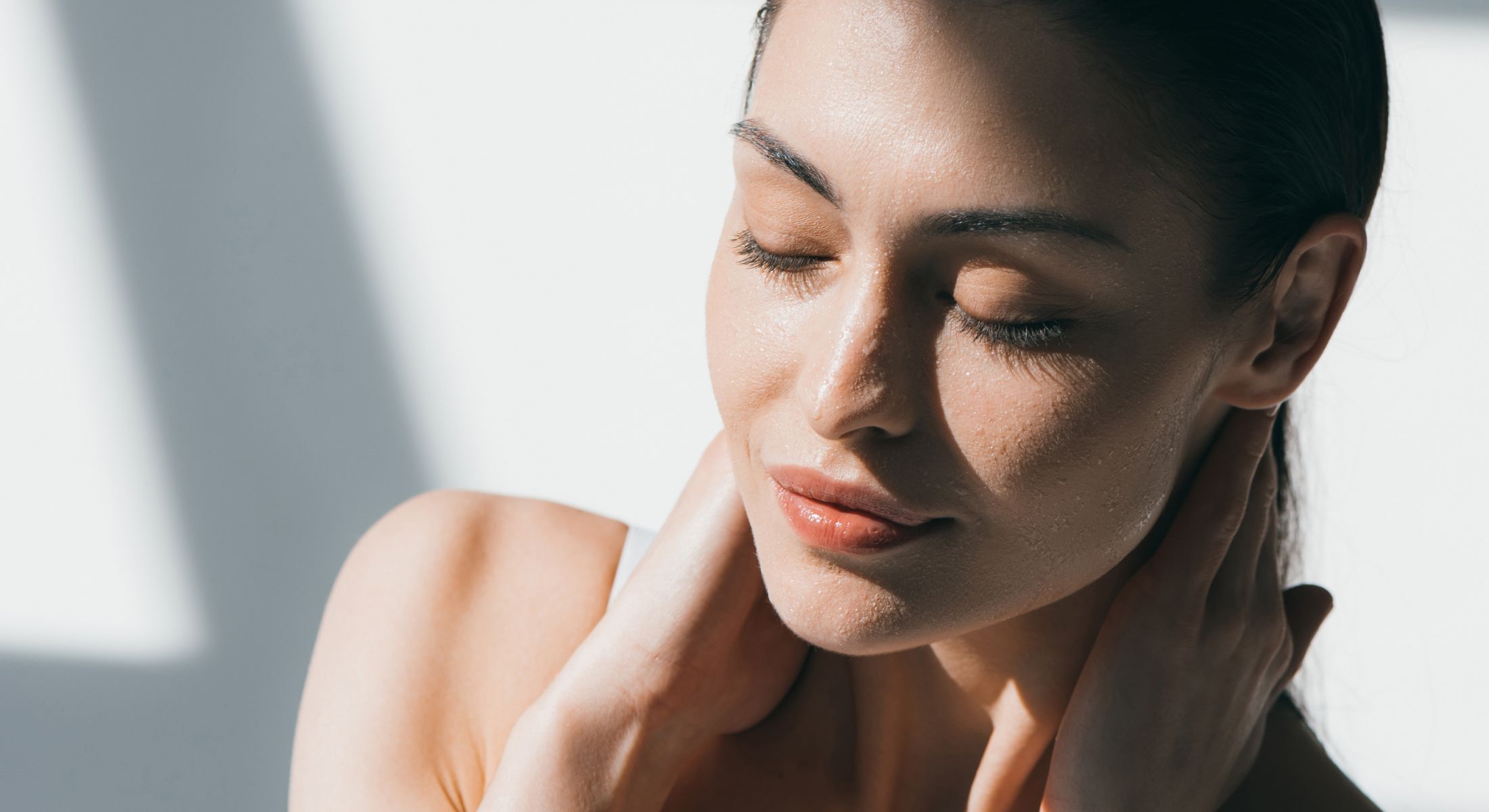 Woman with closed eyes and wet skin.