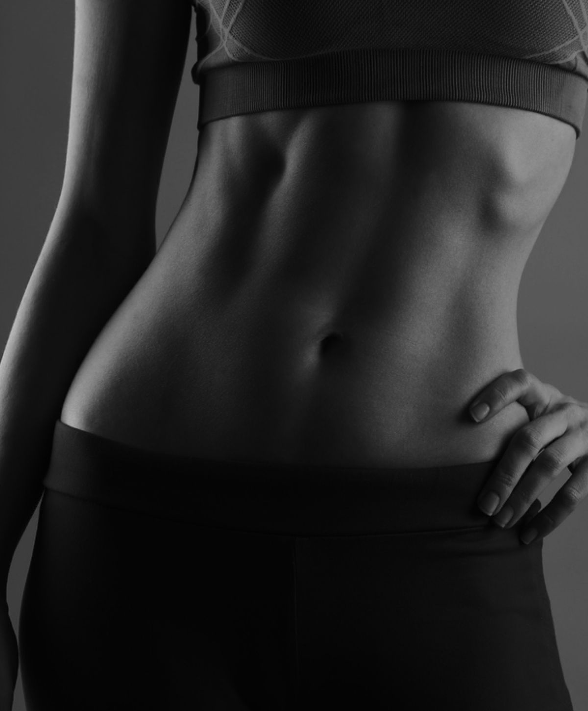 Close-up of athletic figure showcasing toned midsection.